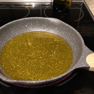 Pour olive oil into a medium skillet to reach a height of about 3 to 4 mm.