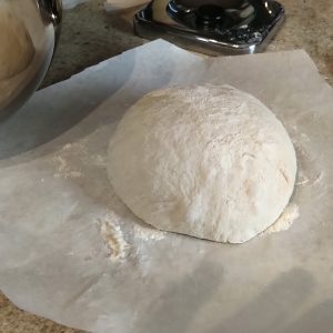 Roll the dough on the baking paper.